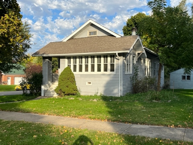 829 North 7th Street Rochelle, IL 61068 - Photo 1 of 24 a front view of a house with a yard and garage