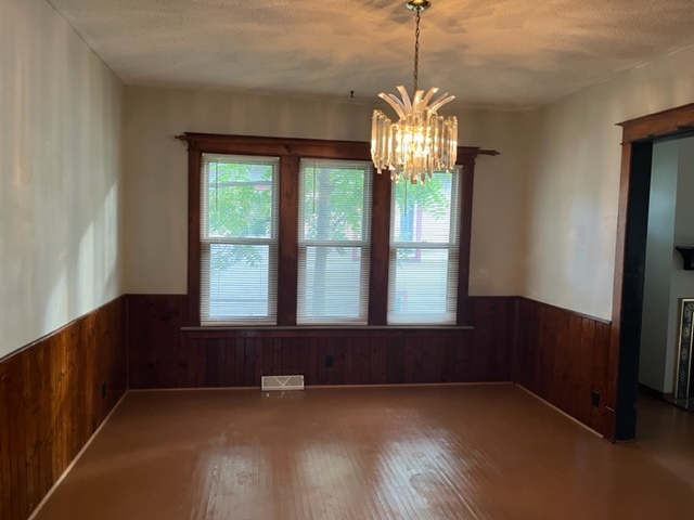 829 North 7th Street Rochelle, IL 61068 - Photo 7 of 24 a view of an empty room with wooden floor and a window