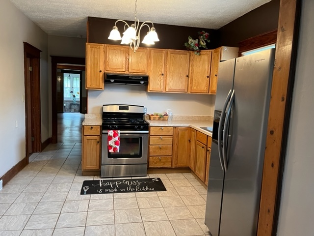 829 North 7th Street Rochelle, IL 61068 - Photo 9 of 24 a kitchen with stainless steel appliances granite countertop a refrigerator a stove top oven a sink and dishwasher