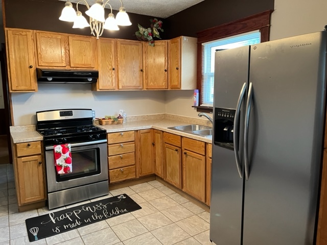 829 North 7th Street Rochelle, IL 61068 - Photo 10 of 24 a kitchen with stainless steel appliances granite countertop a stove a refrigerator and a stove