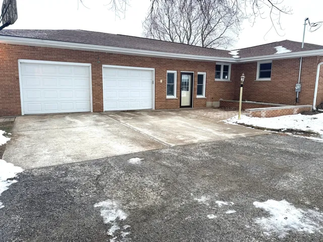 a view of a house with a yard and garage