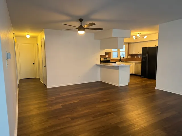 a kitchen with a refrigerator and a sink