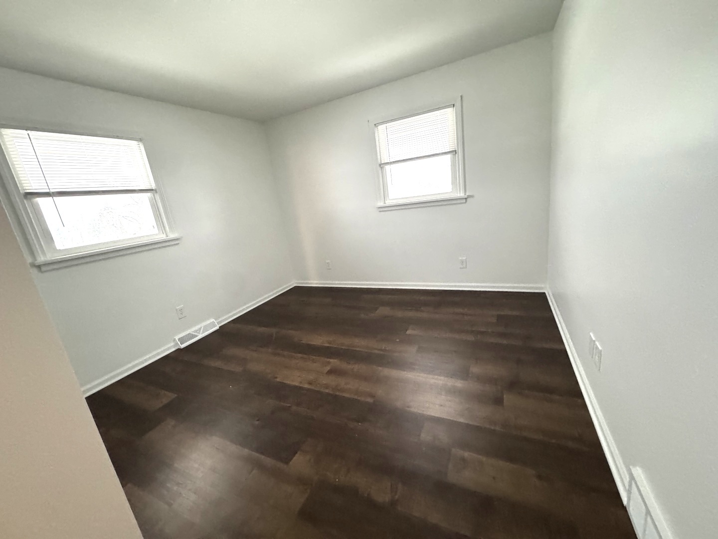 11268 Faxon Road Yorkville, IL 60560 - Photo 10 of 13 an empty room with wooden floor and windows
