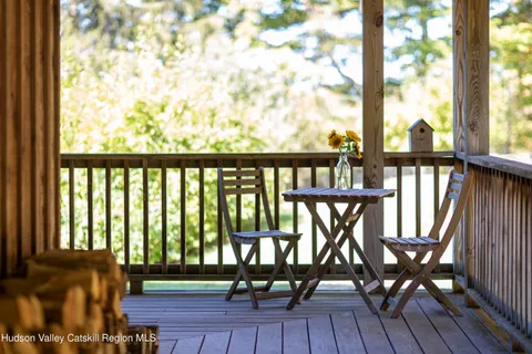 a view of a chairs and table in the balcony