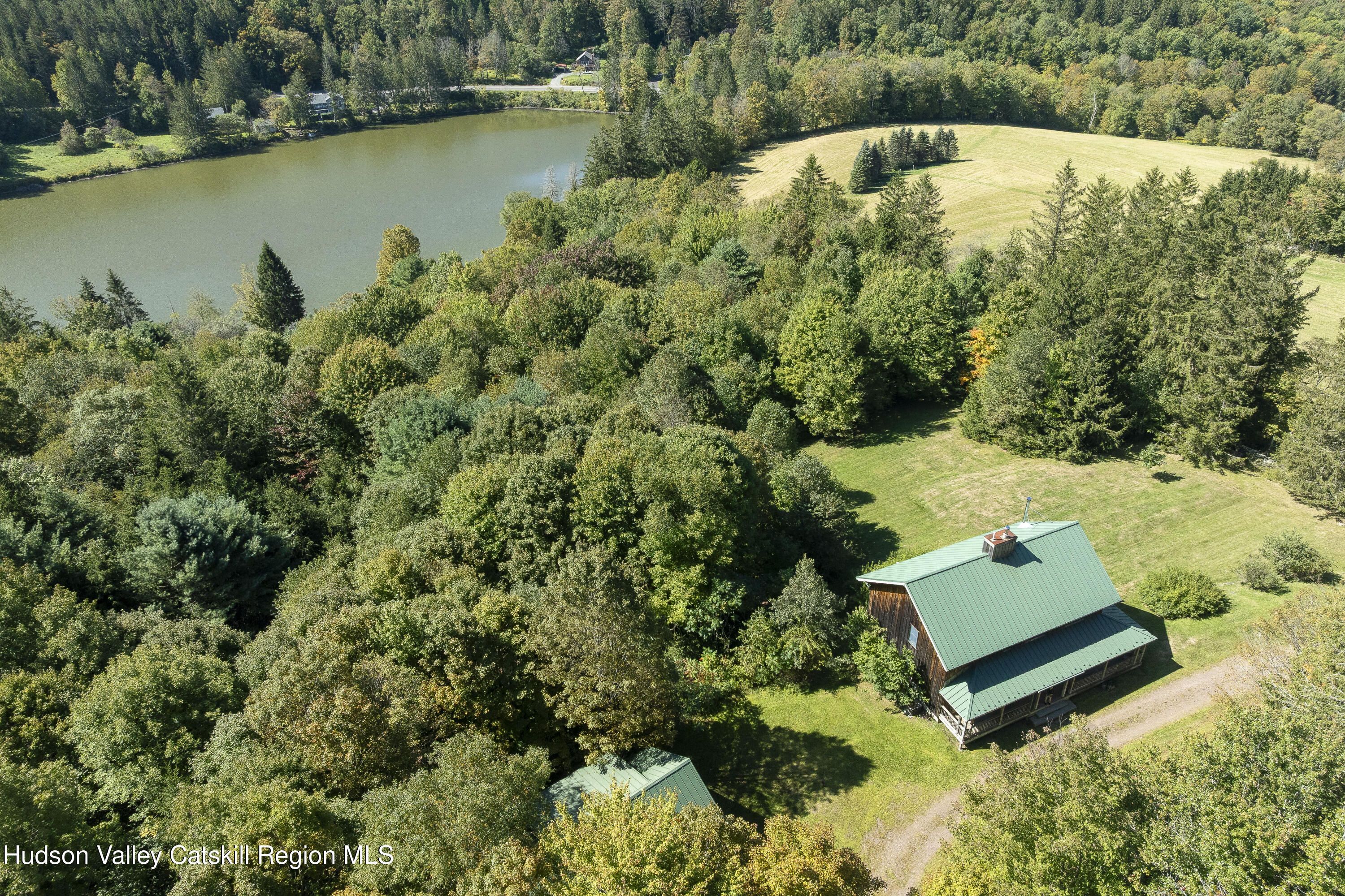 396 Doig Hollow Road Bovina, NY 13731 - Photo 2 of 44 an aerial view of a house with a yard and lake view