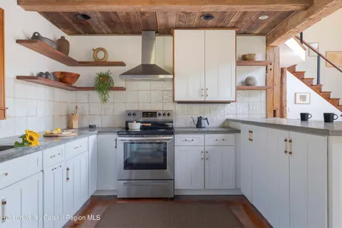 a kitchen with stainless steel appliances granite countertop a sink and cabinets
