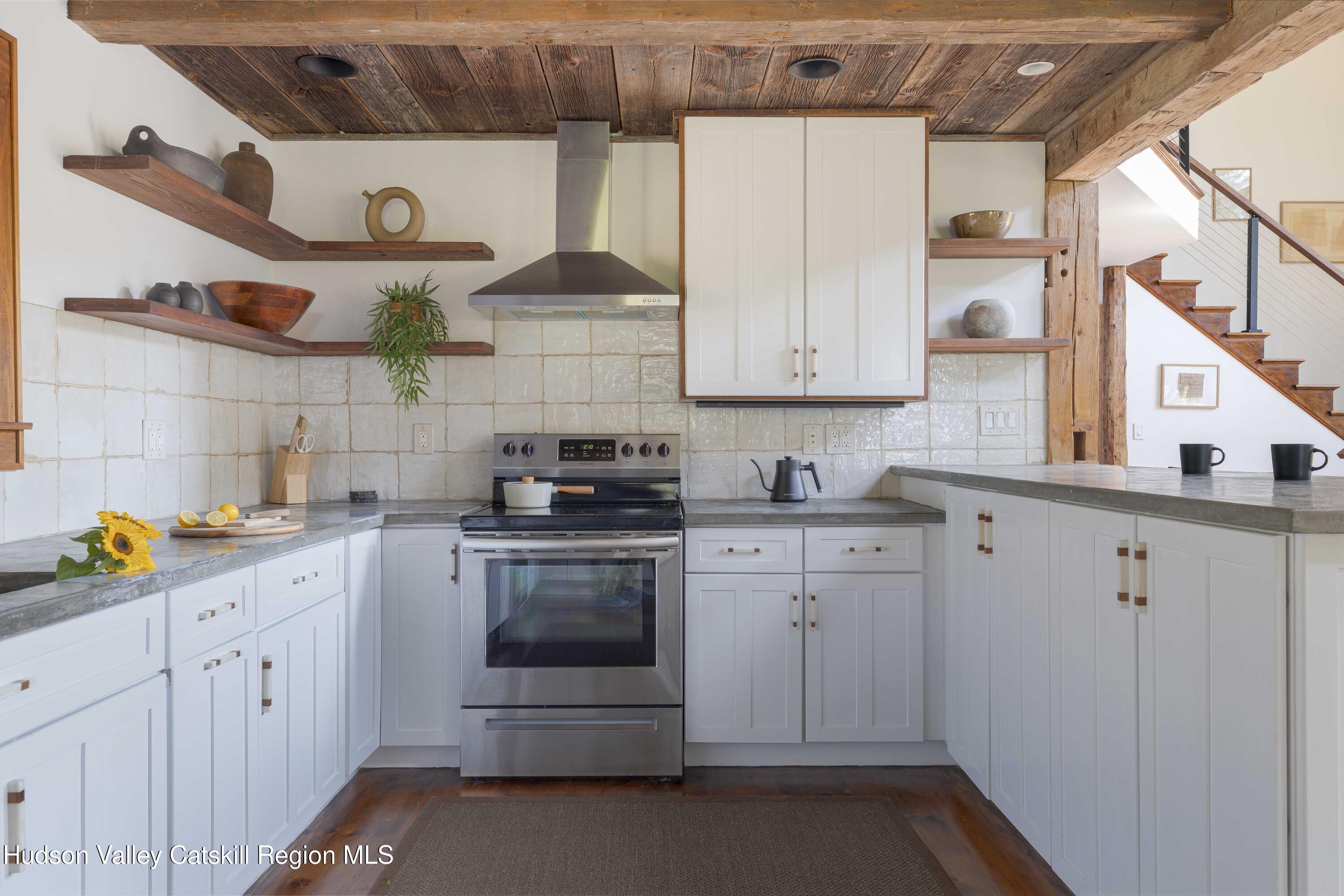 396 Doig Hollow Road Bovina, NY 13731 - Photo 21 of 44 a kitchen with stainless steel appliances granite countertop a sink and cabinets