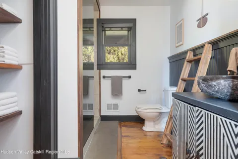 a bathroom with a toilet and a shower