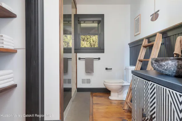 a bathroom with a toilet and a shower