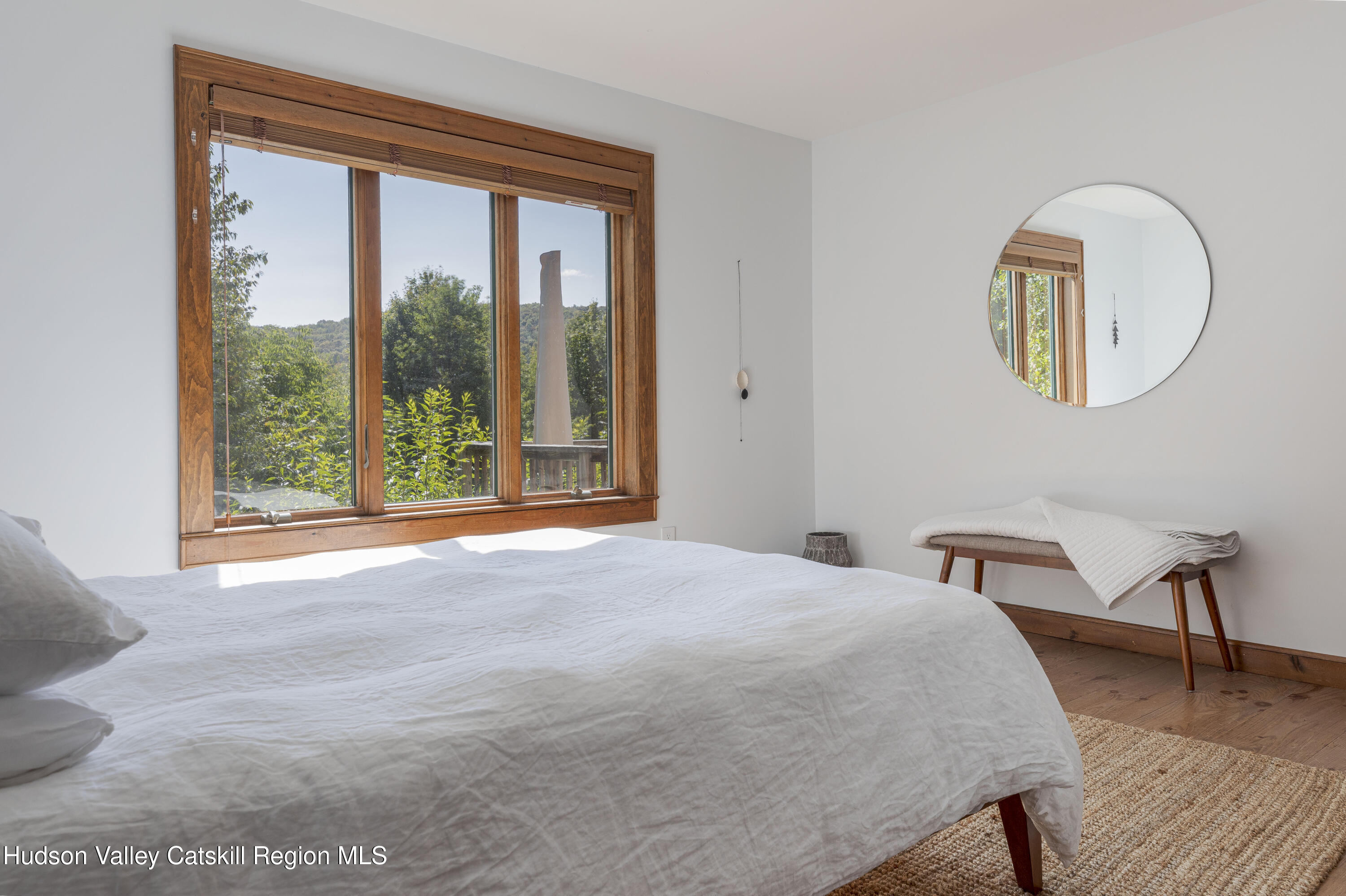 396 Doig Hollow Road Bovina, NY 13731 - Photo 29 of 44 a bedroom with a bed and a large window