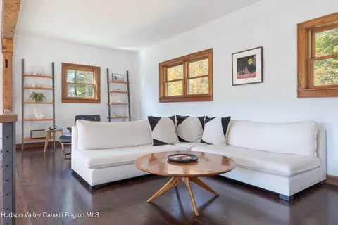 a view of hall way with furniture and windows