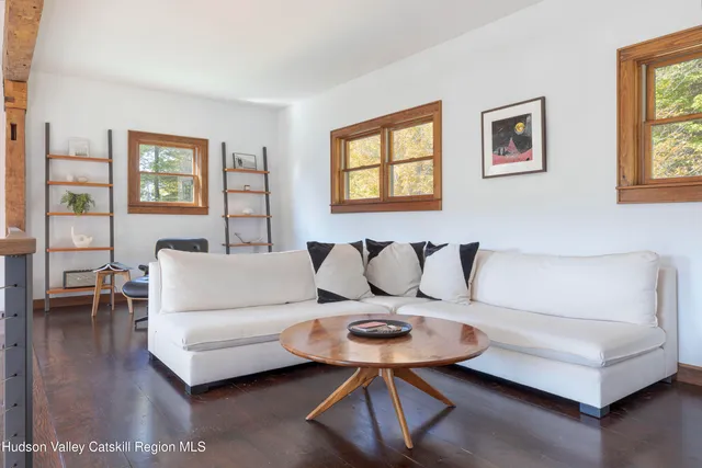 a view of hall way with furniture and windows