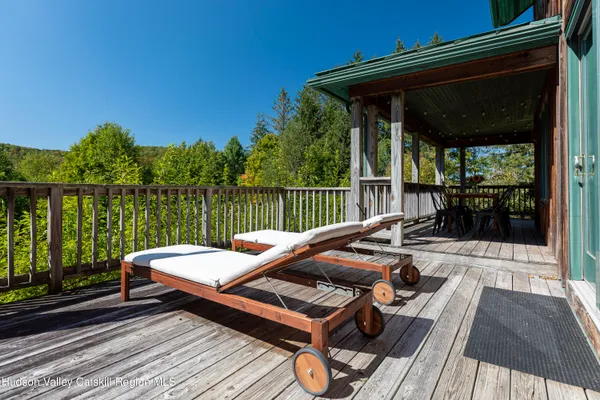 a view of a porch with furniture and wooden floor