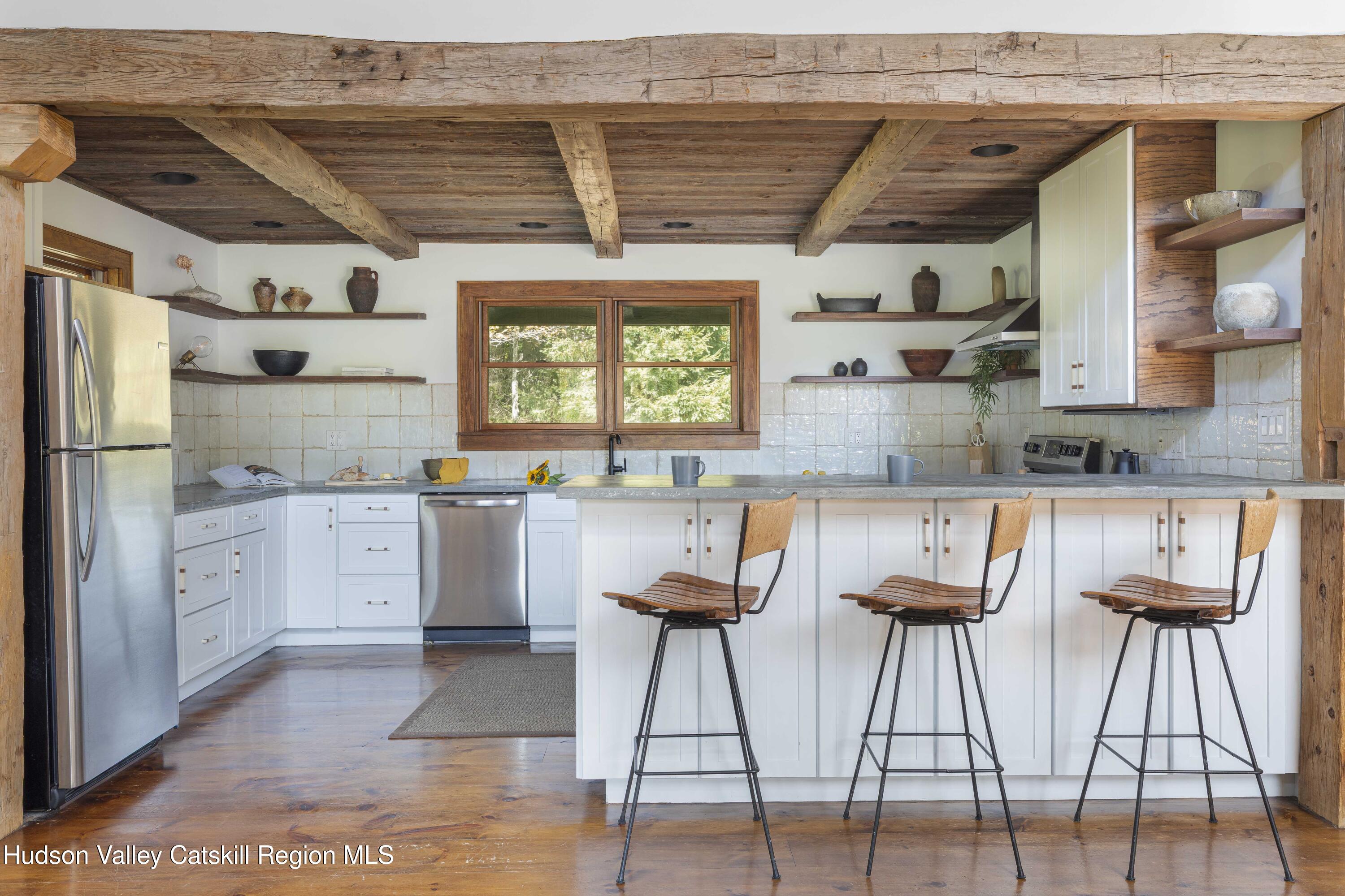 396 Doig Hollow Road Bovina, NY 13731 - Photo 4 of 44 a kitchen with cabinets and chairs
