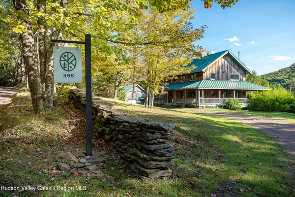 a view of a bench in the garden near a lake