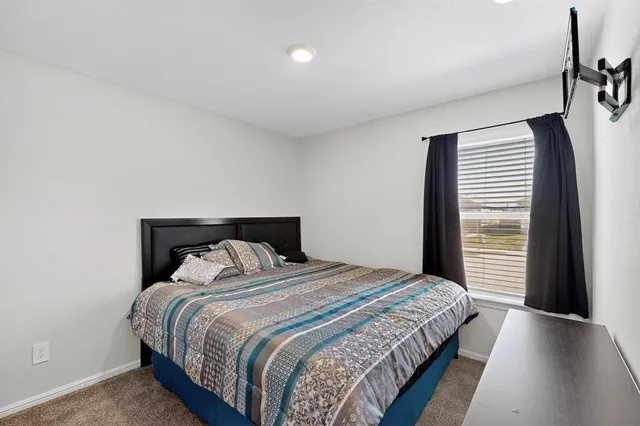 a bedroom with a bed and a large mirror