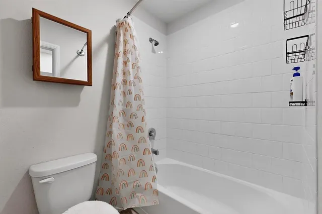 a bathroom with a toilet and a bathtub