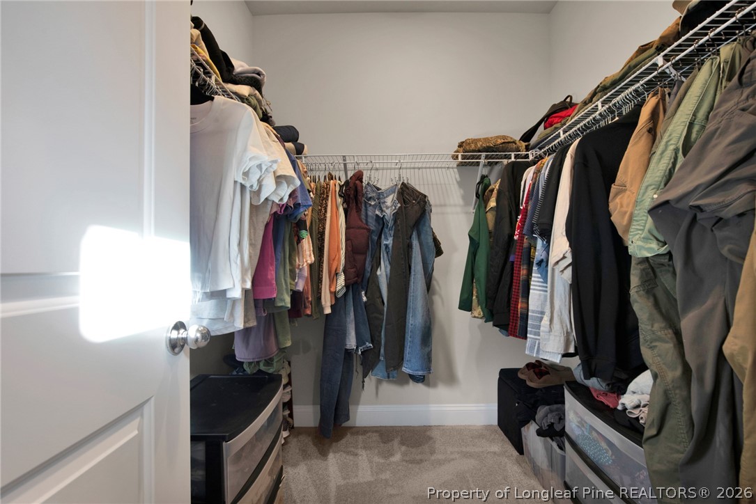 224 Timber Skip Drive Spring Lake, NC 28390 - Photo 16 of 30 a view of walk in closet with clothes and shoes
