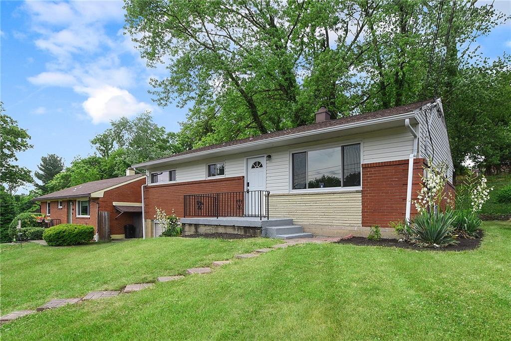 a front view of house with yard and green space