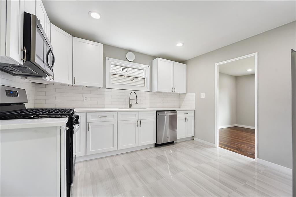 614 Springdale Drive Pittsburgh, PA 15235 - Photo 12 of 31 a kitchen with stainless steel appliances granite countertop a stove a sink and a refrigerator