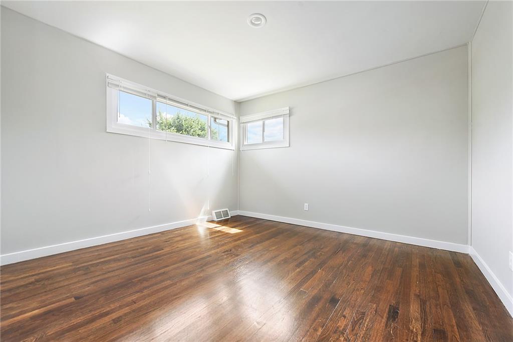 614 Springdale Drive Pittsburgh, PA 15235 - Photo 15 of 31 an empty room with wooden floor and windows
