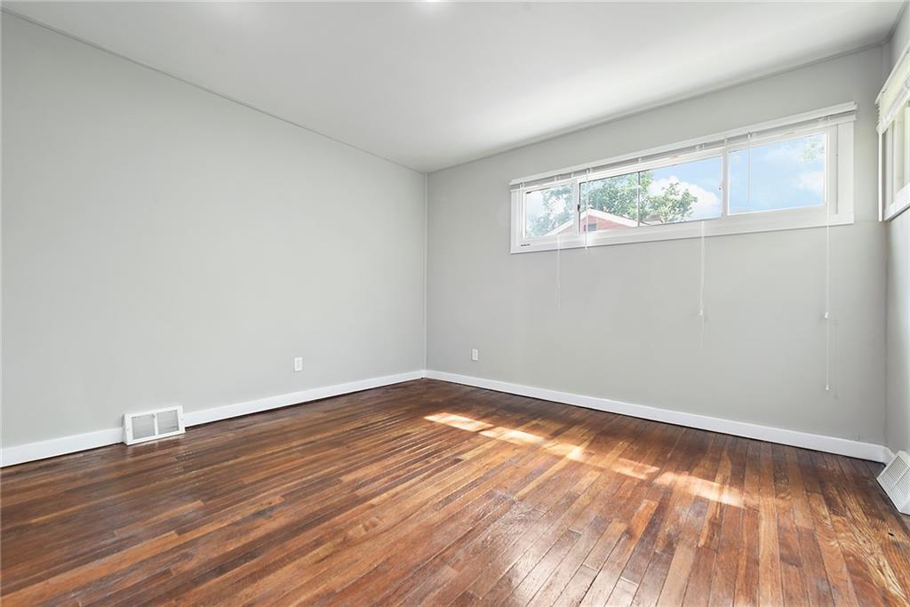 614 Springdale Drive Pittsburgh, PA 15235 - Photo 18 of 31 a view of an empty room with wooden floor and a window