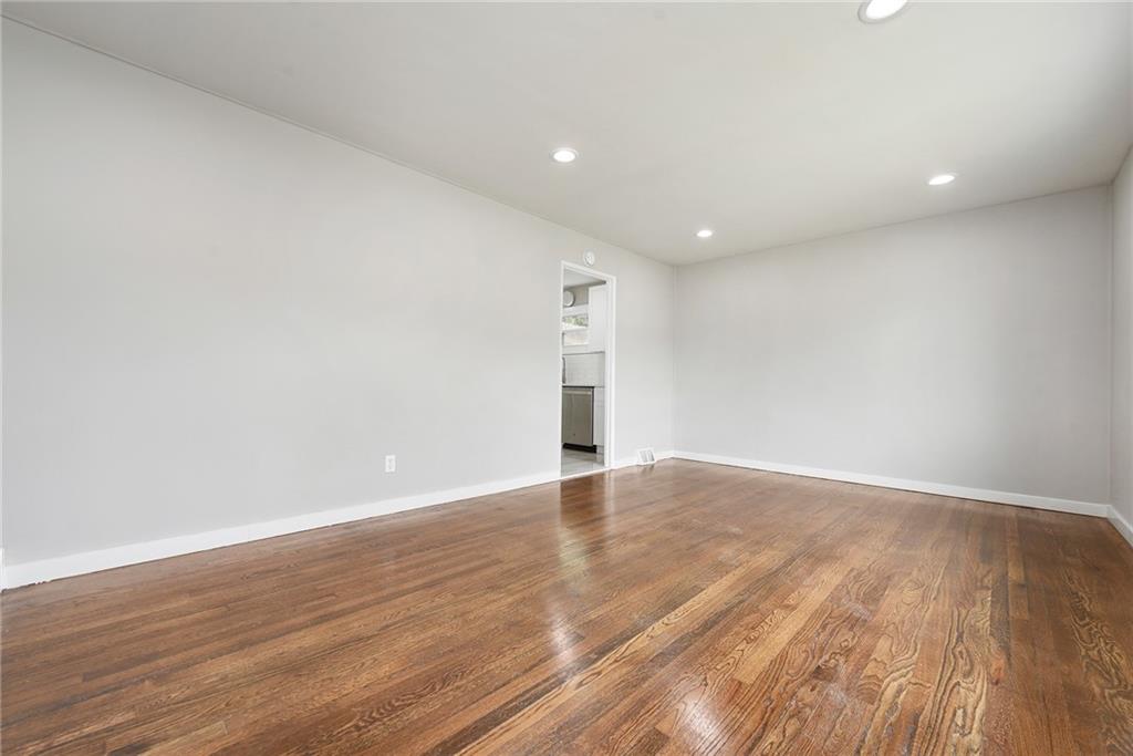 614 Springdale Drive Pittsburgh, PA 15235 - Photo 5 of 31 a view of an empty room with wooden floor and a window