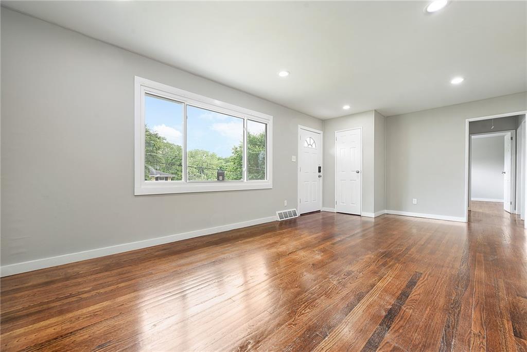 614 Springdale Drive Pittsburgh, PA 15235 - Photo 6 of 31 a view of an empty room with wooden floor and a window