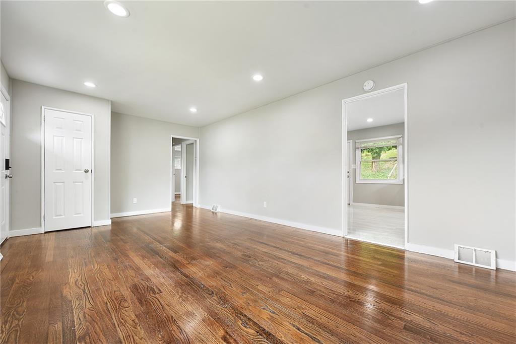 614 Springdale Drive Pittsburgh, PA 15235 - Photo 7 of 31 a view of an empty room with wooden floor and a window