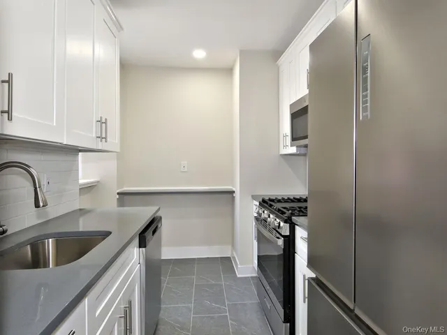 a kitchen with a sink and a refrigerator