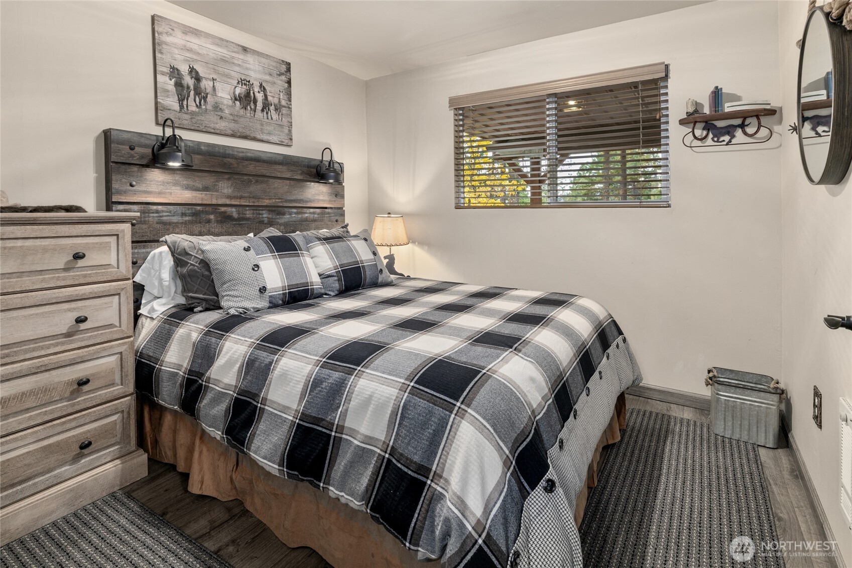 110 Deer Point Lane Ronald, WA 98940 - Photo 21 of 40 a bed sitting in a bedroom next to a window with wooden floor