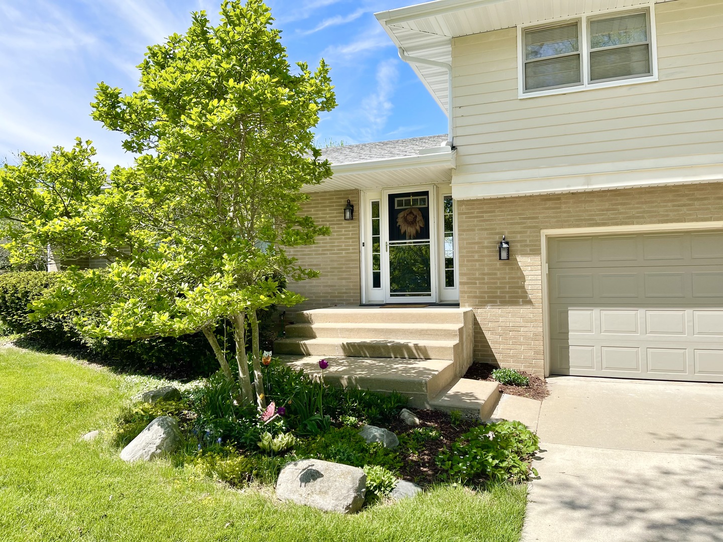 2561 East 259th Road Peru, IL 61354 - Photo 2 of 26 a view of a house with potted plants and a fountain