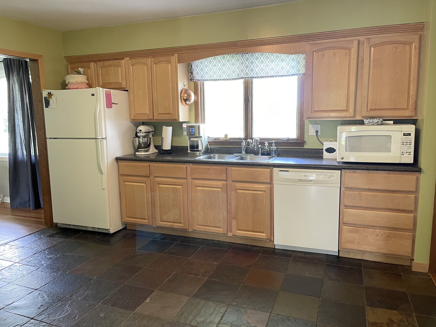 2561 East 259th Road Peru, IL 61354 - Photo 14 of 26 a kitchen with a refrigerator sink and cabinets
