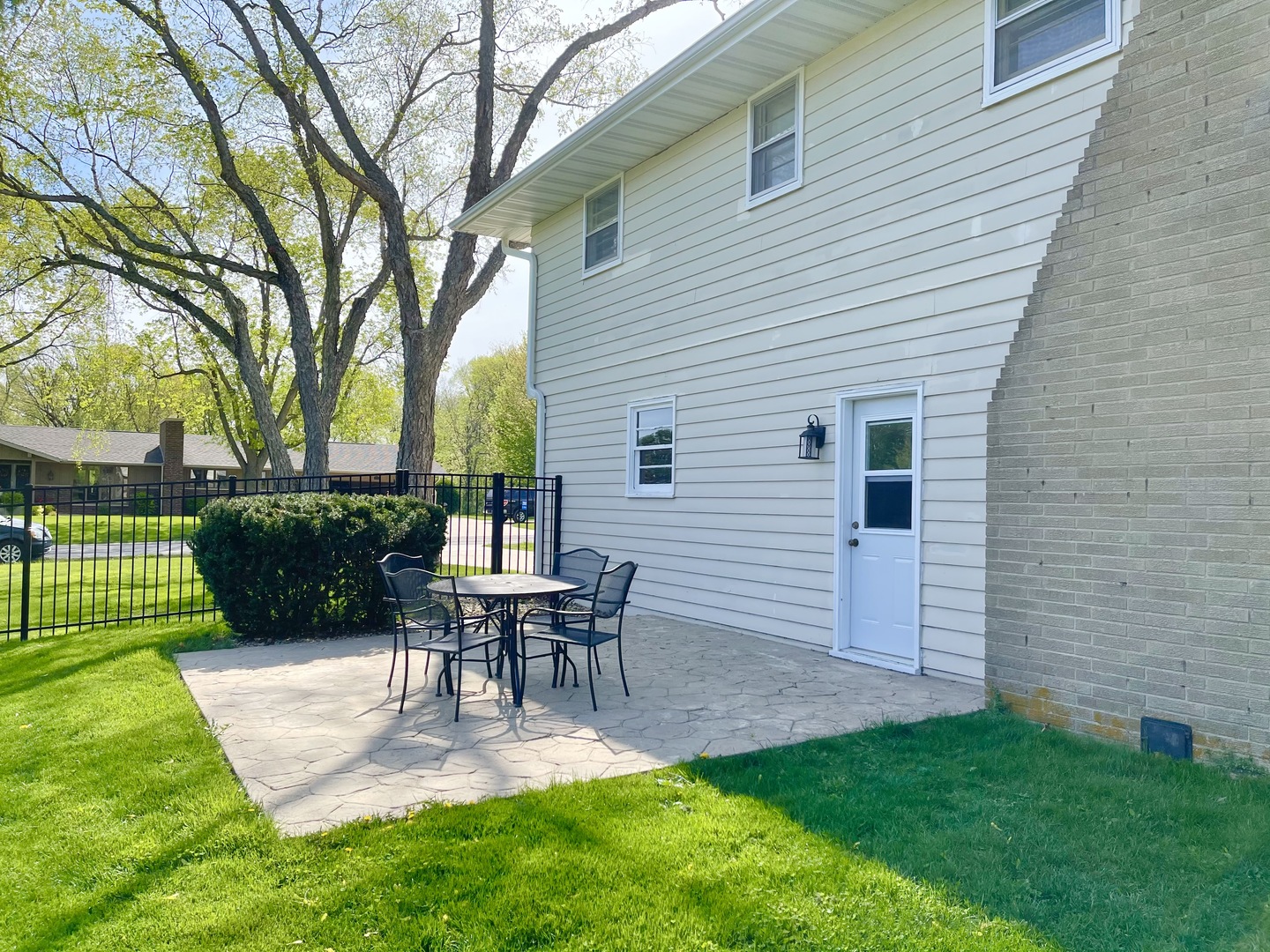 2561 East 259th Road Peru, IL 61354 - Photo 5 of 26 a view of a patio with table and chairs potted plants and a large tree