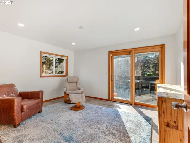 a living room with furniture and a floor to ceiling window