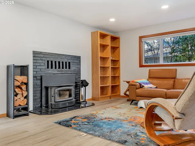 a living room with furniture a window and a fireplace