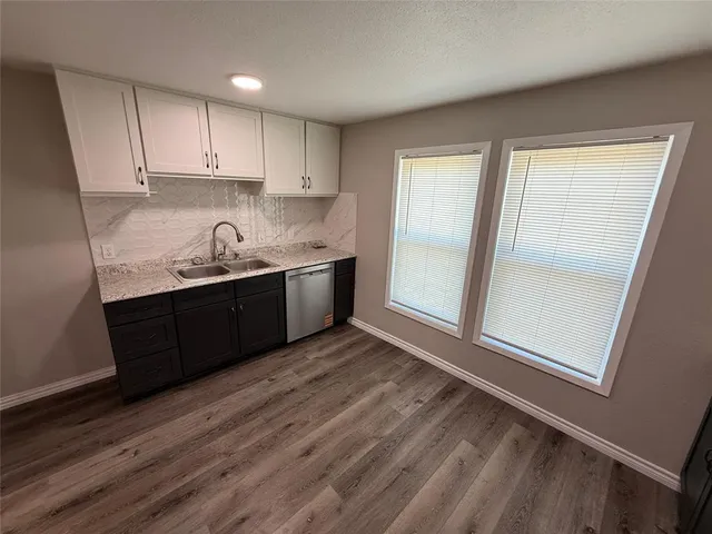 a kitchen with wooden cabinets and sink