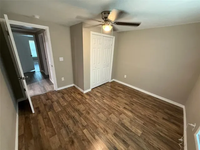 wooden floor in an empty room with a mirror