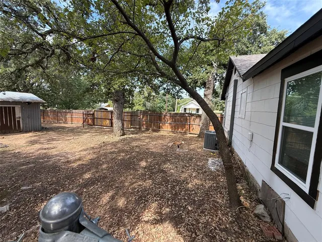 a backyard of a house with table and chairs