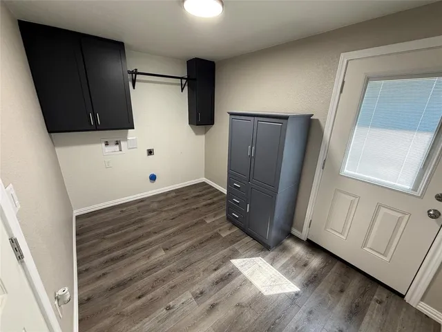 a view of kitchen with wooden floor and electronic appliances