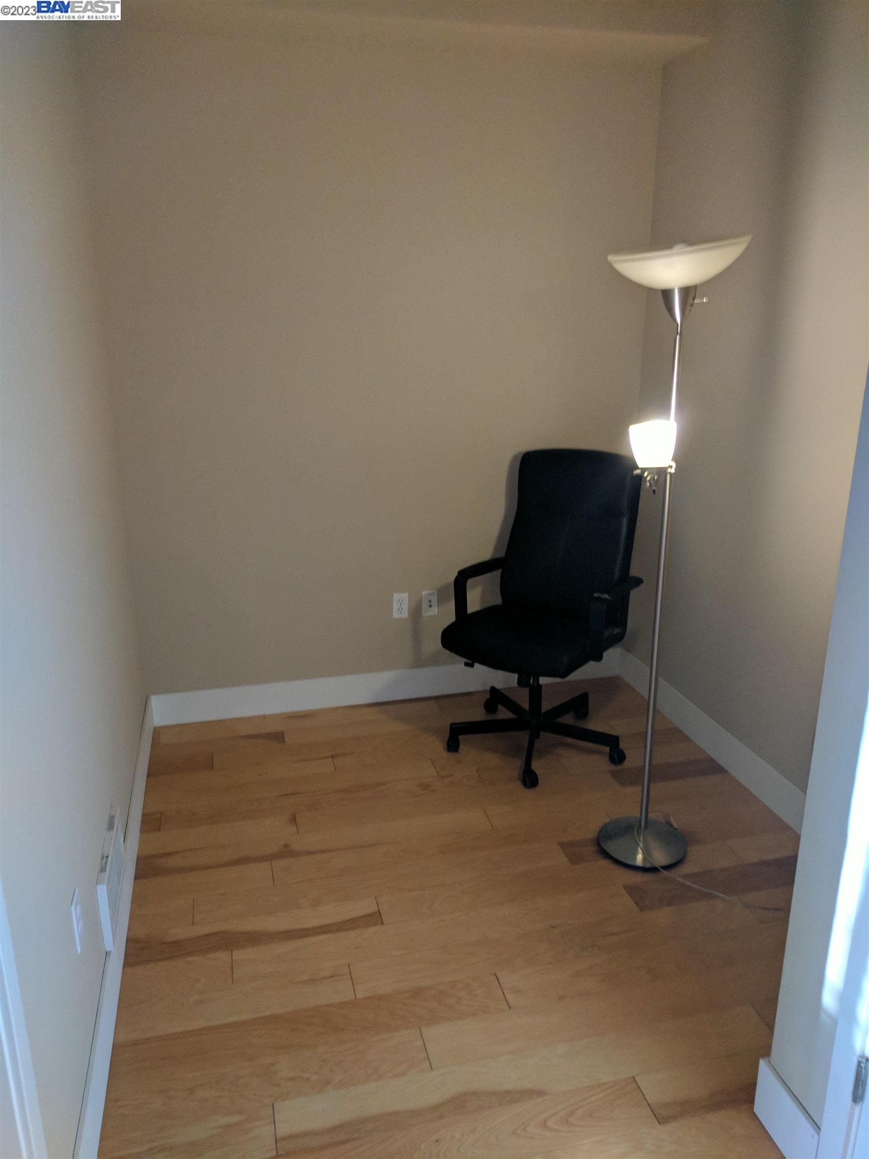 288 3rd Street, Unit 407 Oakland, CA 94607 - Photo 12 of 24 a room with a chair and potted plant