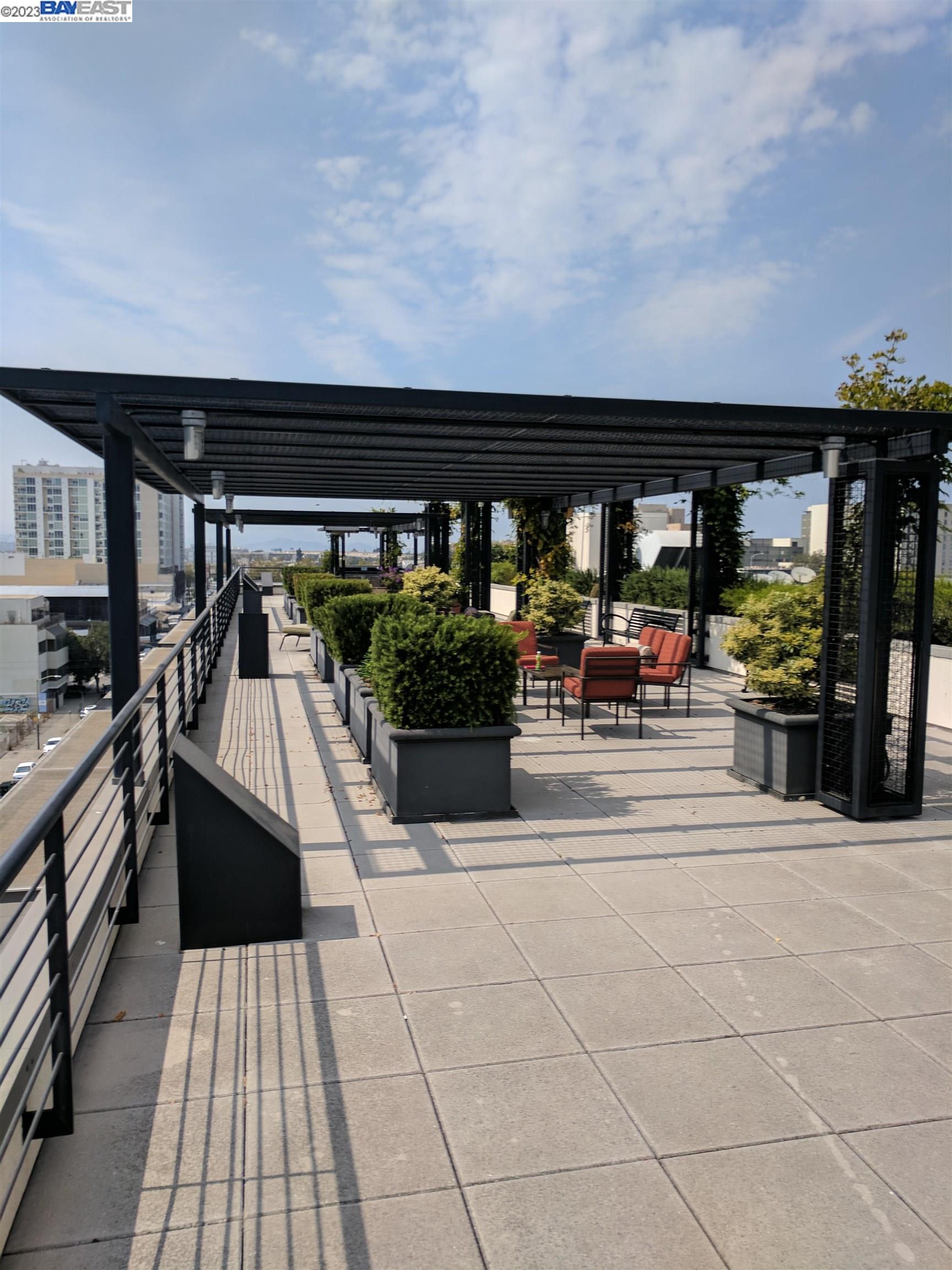 288 3rd Street, Unit 407 Oakland, CA 94607 - Photo 23 of 24 a view of a patio with dining table and chairs with wooden floor