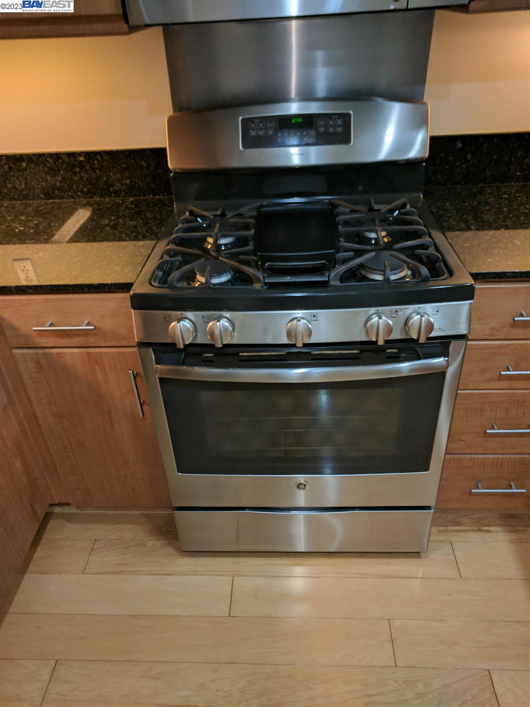 288 3rd Street, Unit 407 Oakland, CA 94607 - Photo 5 of 24 a stove top oven sitting inside of a kitchen