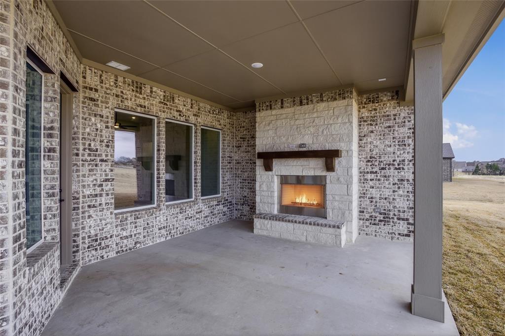 810 Vly Rdg Road Van Alstyne, TX 75495 - Photo 33 of 39 View of patio with an outdoor stone fireplace