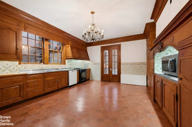a large kitchen with stainless steel appliances granite countertop a stove and cabinets