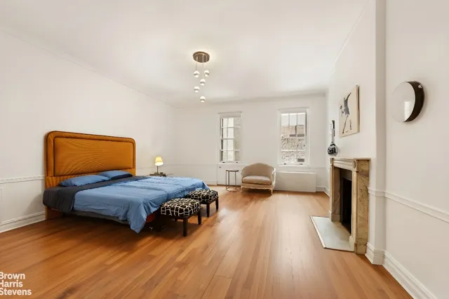 a bedroom with furniture and a wooden floor