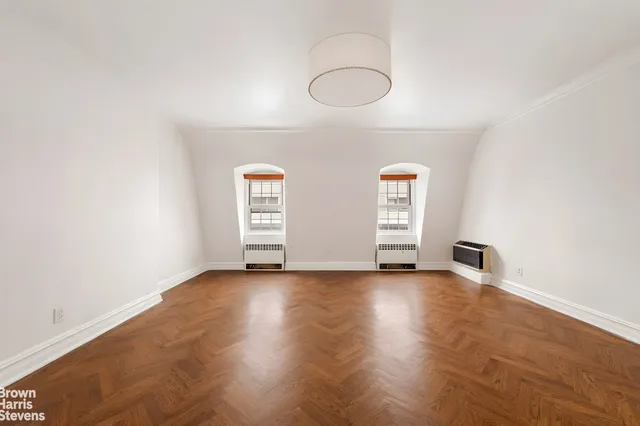 a view of a room with wooden floor and window
