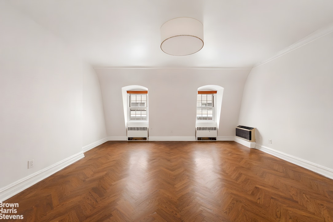 52 East 69th Street Manhattan, NY 10021 - Photo 9 of 20 a view of a room with wooden floor and window