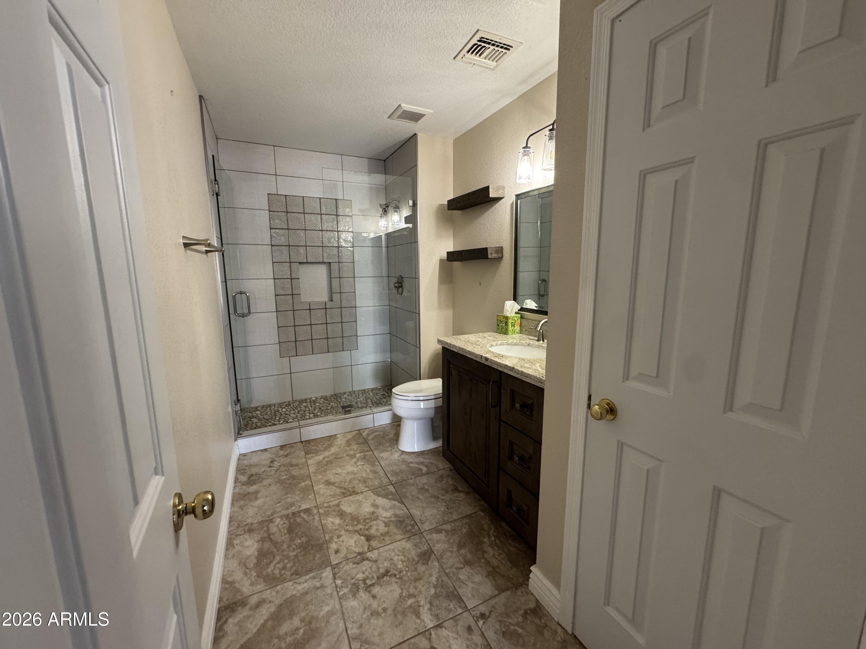 3750 East Orchid Lane Gilbert, AZ 85296 - Photo 23 of 43 a bathroom with a sink a toilet and shower
