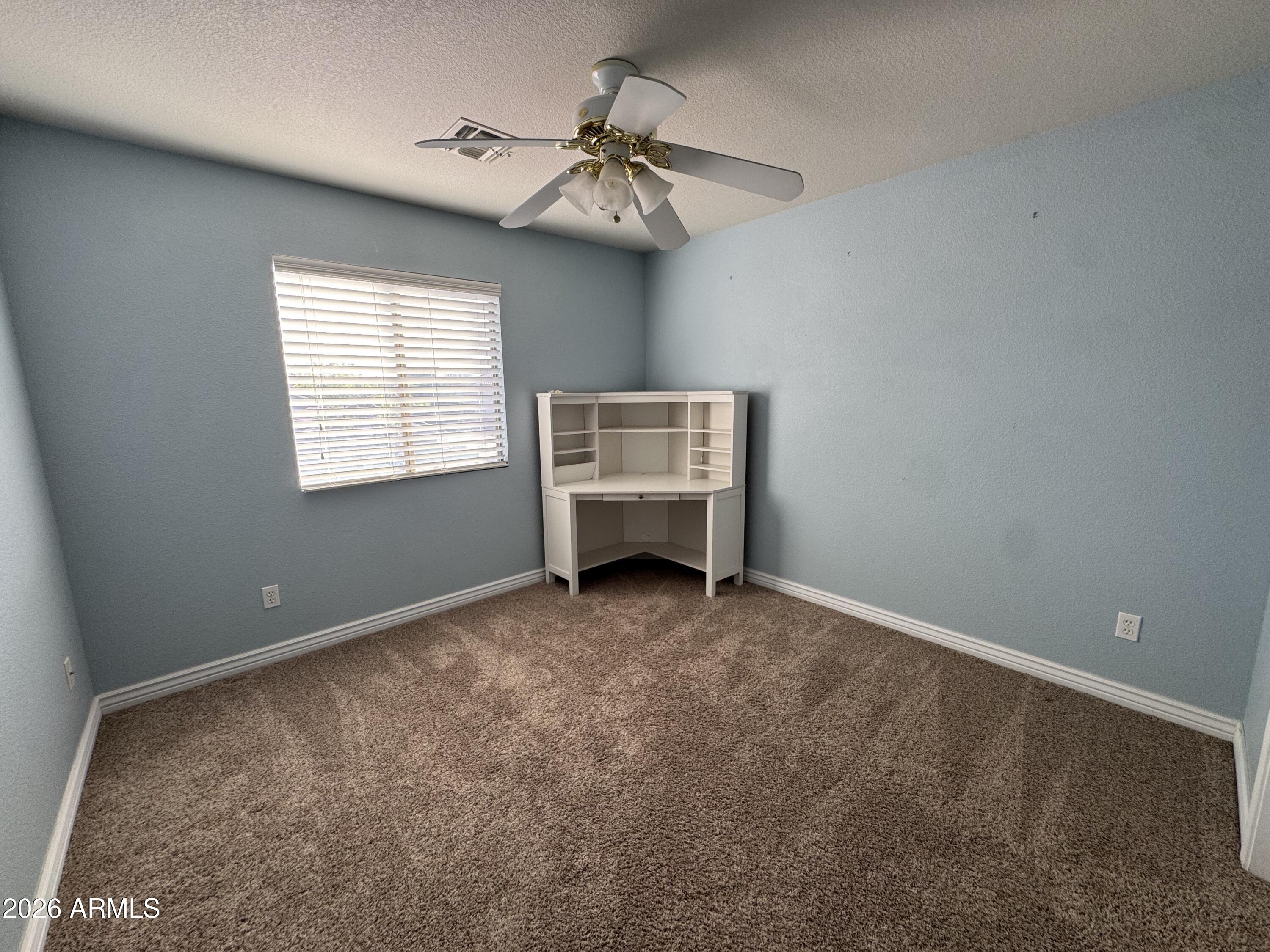 3750 East Orchid Lane Gilbert, AZ 85296 - Photo 27 of 43 an empty room with windows and fan
